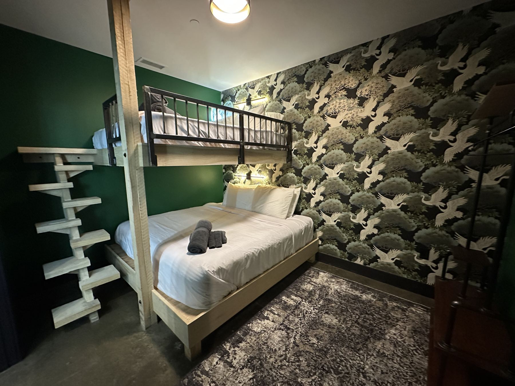 Queen over king bunk room with crane mural wallpaper