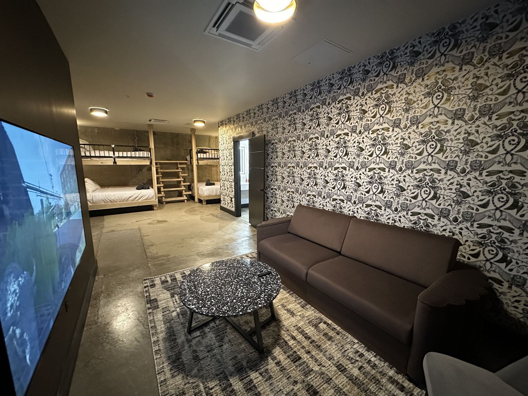 Quad bunk suite with lounge seating and TV